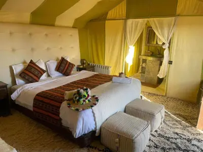 a bedroom with a large bed in a room at Idir Luxury Camp in Merzouga