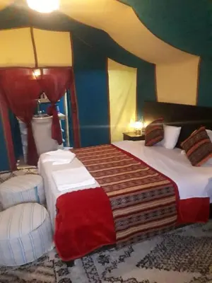 a bedroom with two beds in a room at Idir Luxury Camp in Merzouga