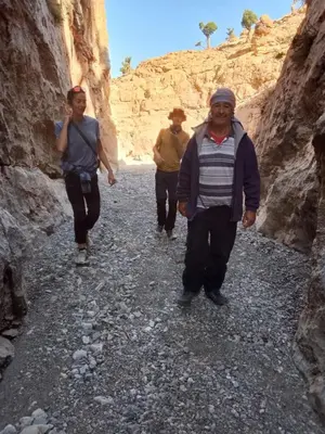 a group of people walking through a canyon at GITE ROURAL TATIOUINE Midelt in Tattiouine