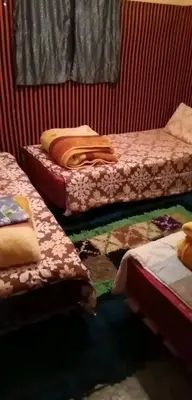 a room with three beds in a roomthritisthritisthritisthritisthritisthritisthritisthritis at GITE ROURAL TATIOUINE Midelt in Tattiouine
