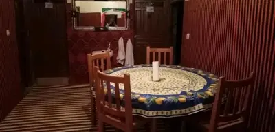 a candle sitting on a table in a room at GITE ROURAL TATIOUINE Midelt in Tattiouine