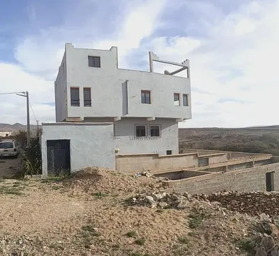 a white house sitting on top of a hill at Auberge Assays in Taliouine