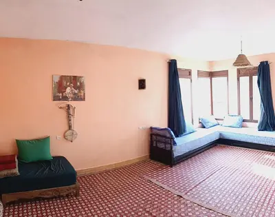a living room with a couch and a window at Auberge Assays in Taliouine