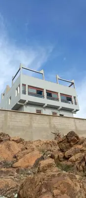 a white house on top of a cliff at Auberge Assays in Taliouine