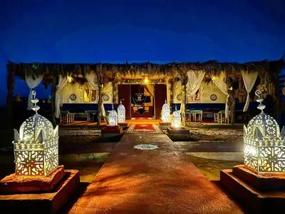 a stage with lights in front of a building at Royal Sands Luxury Camp in Merzouga