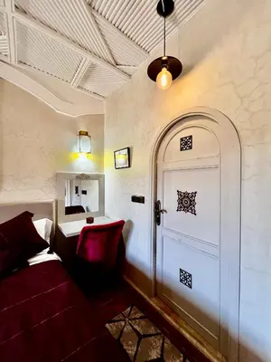 a living room with a couch and a door at Jnane Ayam Atlas in Ourika