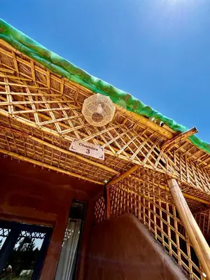 a bamboo roof on top of a building at Jnane Ayam Atlas in Ourika