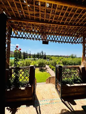 an open gate with a view of a garden at Jnane Ayam Atlas in Ourika