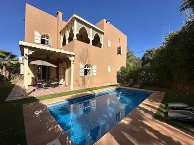 a house with a swimming pool in front of it at Villa Ourika ,Atlas in Ourika