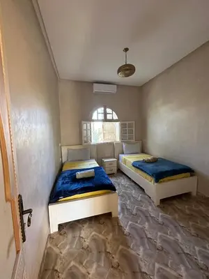 a bedroom with two beds and a window at Villa Ourika ,Atlas in Ourika
