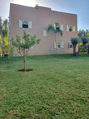 a large house with a tree in front of it at Villa Ourika ,Atlas in Ourika