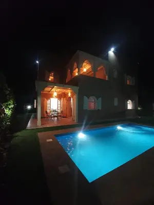 a house with a swimming pool at night at Villa Ourika ,Atlas in Ourika