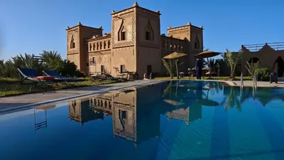 a building with a swimming pool in front of a building at kasba Harmony in Oulad Saïd
