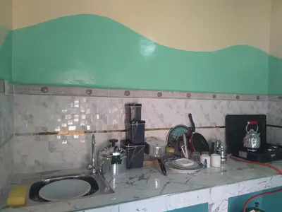 a kitchen counter with a sink and alot of dishes at Studio avec cuisine - kitchen in Tinerhir
