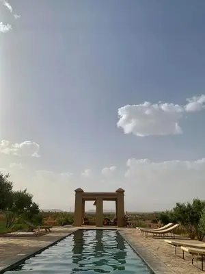 a swimming pool with a monument in the background at Dar faracha in Ouarzazate
