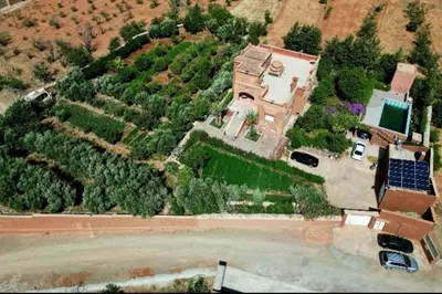 an aerial view of a large house with a pool at chez l'habitant de compagne in Tamensourt