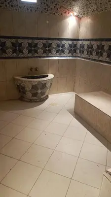 a bathroom with a sink and a tiled floor at chez l'habitant de compagne in Tamensourt