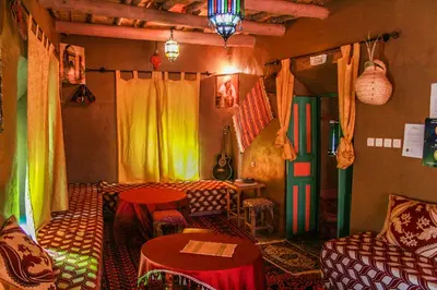 a living room with a couch and a table at Kasbah Maison D’hôte Lalla Zahra in Aït Baha