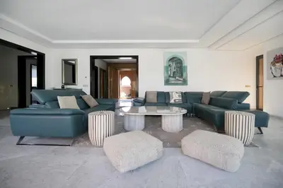 a living room with blue couches and a table at DAR KAYIS & LAILA in Marrakech