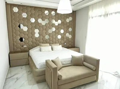 a bedroom with a bed and a couch and a chair at Villa Magnolia Meknès Oasis de paix pour famille in Meknès
