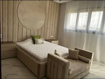 a bedroom with a large bed and a chair at Villa Magnolia Meknès Oasis de paix pour famille in Meknès