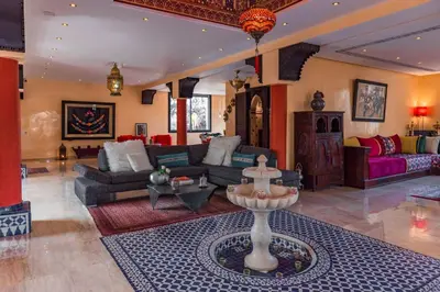 a large living room with couches and a fountain at Villa pension complète Marrakech in Marrakech