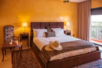 a bedroom with a large bed with a hat on it at Villa pension complète Marrakech in Marrakech