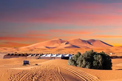a desert with a building in the middle of it at desert luxury merzouga in Merzouga