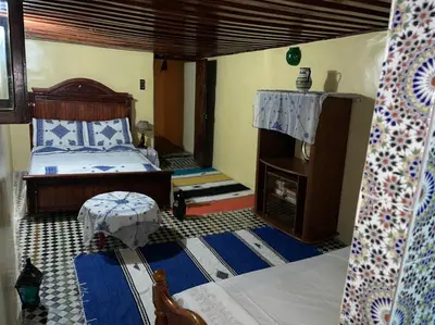 a bedroom with a bed and a fireplace at chambres chez Naima Mbarki in Fès