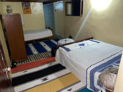 a small room with a bed and a mirror at chambres chez Naima Mbarki in Fès