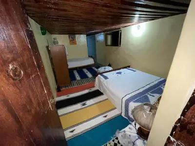 a small room with a bed and a chair at chambres chez Naima Mbarki in Fès