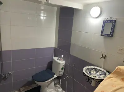 a bathroom with a toilet and a sink at chambres chez Naima Mbarki in Fès