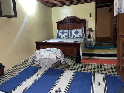 a bedroom with a bed with blue and white at chambres chez Naima Mbarki in Fès