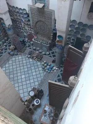 an overhead view of a patio with a table and a fireplace at suite 3 people Naima mbarki in Fès