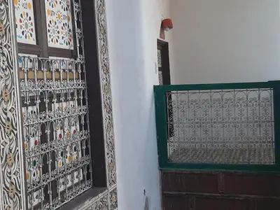 a door to a building with a decorative wall at suite 3 people Naima mbarki in Fès