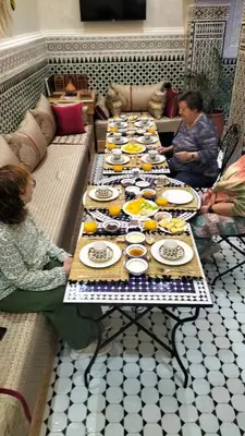 a group of tables with plates of food on them at Riad Diamant Bleu in Fès