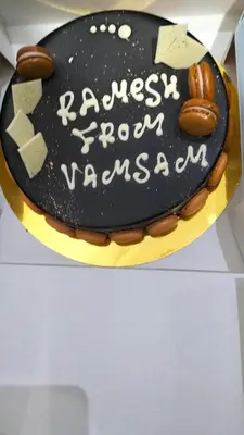 a black cake with writing on it on a box at Riad Diamant Bleu in Fès
