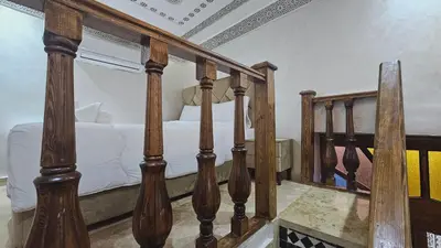 a staircase leading to a bedroom with a bed at Riad Diamant Bleu in Fès