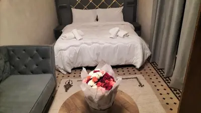 a bedroom with a bed and a table with flowers on it at Riad Diamant Bleu in Fès