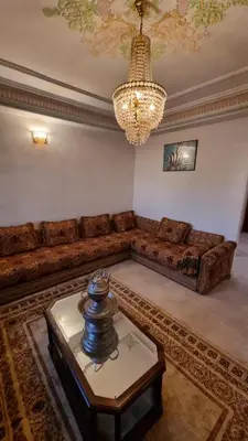 a living room with a couch and a table at Villa with riad style in Fès