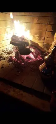 a fire pit with a piece of meat on the ground at Villa with riad style in Fès