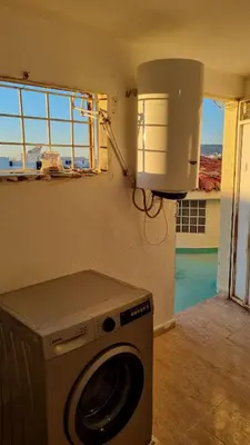 a washing machine in a room with a window at Villa with riad style in Fès