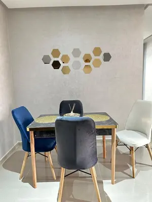a dining room with a table and four chairs at Hood houses in Ouarzazate