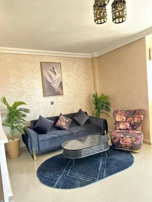 a living room with a couch and a chair at Hood houses in Ouarzazate
