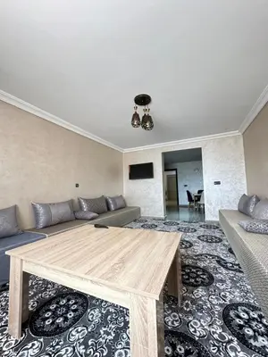 a living room with a couch and a table at Hood houses in Ouarzazate