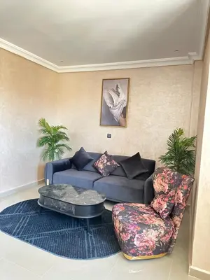 a living room with a couch and a chair at Hood houses in Ouarzazate