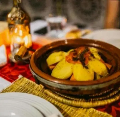 a bowl of food on top of a table at Riad Dar Maria in Merzouga