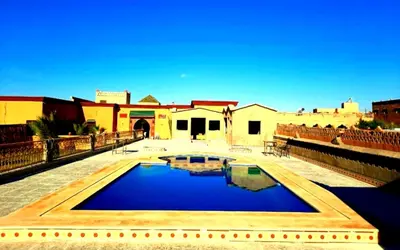 a swimming pool in the middle of a building at Riad Dar Maria in Merzouga