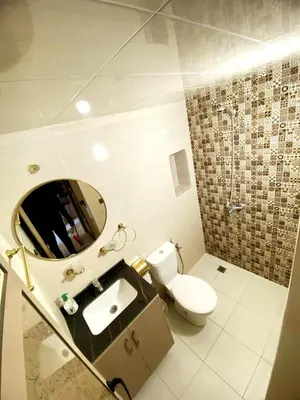 a bathroom with a toilet and a sink and a mirror at (1) Appartement calme in Fès