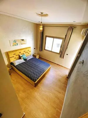 a bedroom with a large bed in a room at (1) Appartement calme in Fès